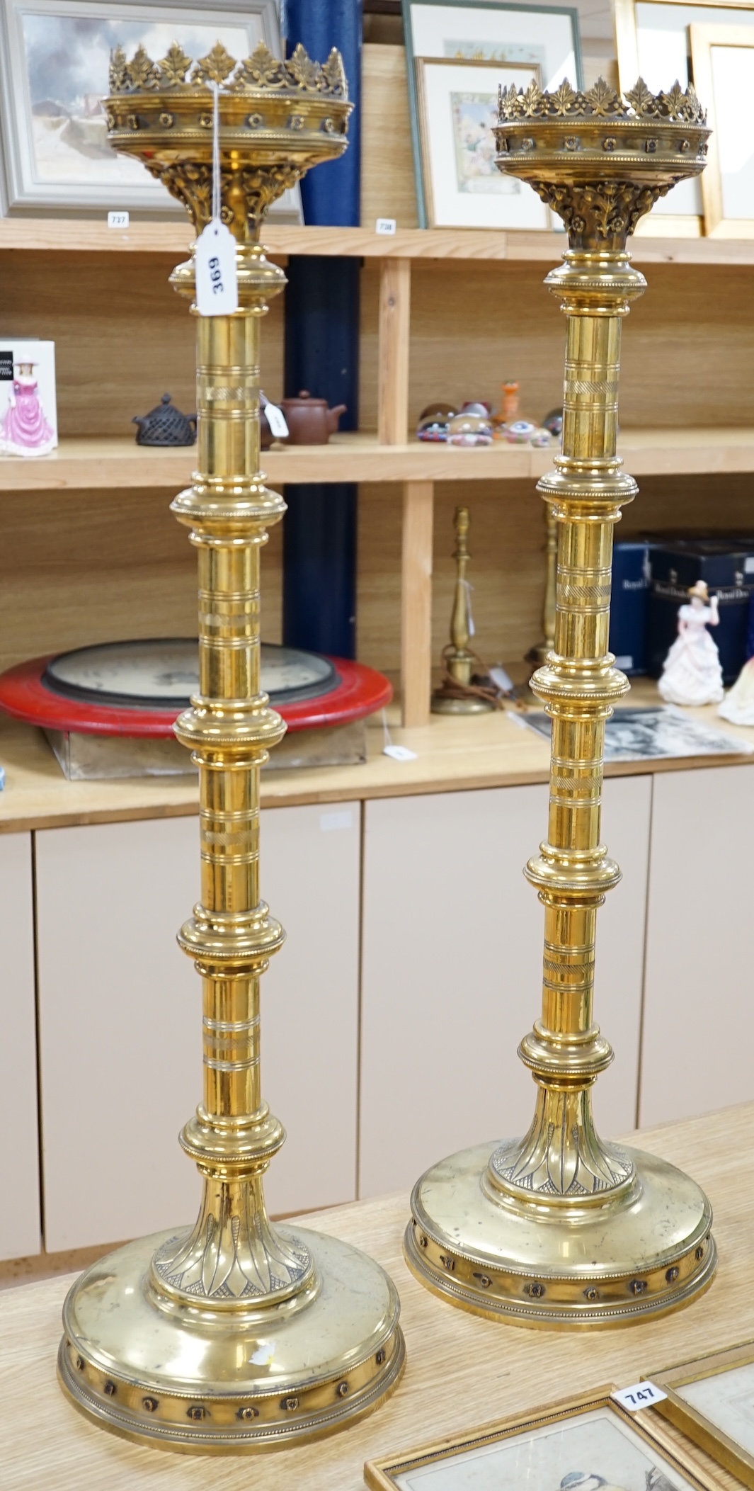 A pair of 19th century tall decorative brass ecclesiastical candlesticks, 90cm high. Condition - fair to good
